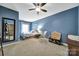 Blue bedroom features a full size mirror, ceiling fan, and comfortable furnishings at 998 Emory Ln, Fort Mill, SC 29708
