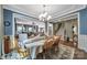 The dining room with an elegant chandelier flows into the living room and features a staircase at 998 Emory Ln, Fort Mill, SC 29708