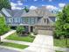 Aerial view of a two-story home with blue siding, stone accents, a two-car garage, and a well-maintained lawn at 998 Emory Ln, Fort Mill, SC 29708
