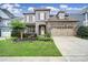 Beautiful two-story home featuring a stone facade, two-car garage, and manicured front lawn at 998 Emory Ln, Fort Mill, SC 29708
