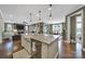 Spacious open-concept kitchen island with bar seating, hardwood floors, connecting seamlessly to living and dining areas at 998 Emory Ln, Fort Mill, SC 29708
