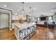 Open kitchen with island seating, pendant lights, stainless appliances, and seamless flow to the living room at 998 Emory Ln, Fort Mill, SC 29708