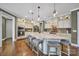 Modern kitchen features a large island, pendant lighting, stainless steel appliances, and hardwood floors at 998 Emory Ln, Fort Mill, SC 29708