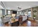Bright living room boasts a stone fireplace, large windows, comfortable seating, and hardwood floors at 998 Emory Ln, Fort Mill, SC 29708