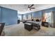 Spacious main bedroom with a sitting area, tray ceilings, and plush carpet at 998 Emory Ln, Fort Mill, SC 29708