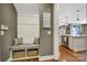Mudroom with storage bench, coat hooks, and woven baskets leading into the kitchen at 998 Emory Ln, Fort Mill, SC 29708