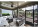 Relaxing screened in porch offers comfortable wicker furniture, ceiling fan, and views of the backyard at 998 Emory Ln, Fort Mill, SC 29708