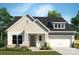 Charming craftsman-style home featuring vertical siding, stone accents and a two-car garage at 1015 Idyllic Ln, Waxhaw, NC 28173