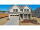 Charming two-story home with a manicured lawn, a two-car garage, and a welcoming front porch at 1048 Waxhaw Crossing Dr # 261, Waxhaw, NC 28173