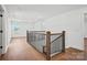 Upper hallway with wood floors and black metal railings and a view to the neighborhood outside at 1048 Waxhaw Crossing Dr # 261, Waxhaw, NC 28173