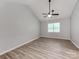 Vaulted ceiling bedroom with modern ceiling fan and neutral walls over wood-look floors at 10736 Spruce Mountain Rd, Charlotte, NC 28214