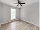 Light-filled bedroom with ceiling fan and light vinyl floors at 10736 Spruce Mountain Rd, Charlotte, NC 28214