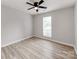 Neutral bedroom with plank flooring and a modern ceiling fan at 10736 Spruce Mountain Rd, Charlotte, NC 28214