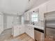 Bright, modern kitchen featuring white cabinets, stainless steel appliances, and stylish countertops at 10736 Spruce Mountain Rd, Charlotte, NC 28214