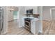 Open-concept kitchen with modern appliances and view into adjoining dining room at 10736 Spruce Mountain Rd, Charlotte, NC 28214