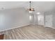 Open-concept living area with vaulted ceilings, fan, and natural light, showcasing neutral paint at 10736 Spruce Mountain Rd, Charlotte, NC 28214