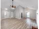 Bright living room with vaulted ceilings and hardwood floors showcasing the front door and staircase at 10736 Spruce Mountain Rd, Charlotte, NC 28214