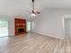 Bright living room with vaulted ceilings and hardwood floors showcasing the fireplace and sliding door at 10736 Spruce Mountain Rd, Charlotte, NC 28214