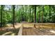 A wood deck offers views of a wooded backyard with mature trees and a small storage shed at 109 Pepper Cir, Mooresville, NC 28117