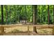Wooden deck overlooking a lush backyard with mature trees and a storage shed at 109 Pepper Cir, Mooresville, NC 28117