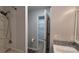 Bathroom featuring a shower and a vanity with gray tile backsplash, leading to a walk-in closet at 109 Pepper Cir, Mooresville, NC 28117