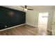 Spacious bedroom features hardwood floors, ceiling fan and blue accent wall at 109 Pepper Cir, Mooresville, NC 28117