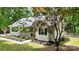 Cozy home with landscaped front yard, porch with hanging plants, and leafy surrounding trees at 109 Pepper Cir, Mooresville, NC 28117