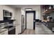 Modern kitchen with stainless steel appliances, granite countertops, and white cabinets at 109 Pepper Cir, Mooresville, NC 28117