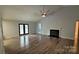 Open living room featuring hardwood floors, a fireplace, and large windows for natural light at 109 Pepper Cir, Mooresville, NC 28117