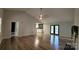 Open living room featuring hardwood floors, high ceilings, and view to the kitchen at 109 Pepper Cir, Mooresville, NC 28117