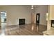 Spacious living room with a fireplace, hardwood floors, and view of the laundry room at 109 Pepper Cir, Mooresville, NC 28117