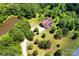 An aerial view shows a house nestled among trees, complemented by a pond and driveway at 114 Wingard Rd, Concord, NC 28025