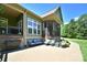 View of a beautiful, furnished outdoor patio and screened-in porch area at 114 Wingard Rd, Concord, NC 28025