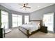 Bright bedroom featuring neutral walls, carpet, and ceiling fan, exuding a modern and cozy feel at 114 Wingard Rd, Concord, NC 28025