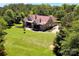 A charming house with a lush green lawn and mature trees providing privacy and a serene setting at 114 Wingard Rd, Concord, NC 28025