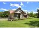 Beautiful exterior angle shows the home's lush landscaping and attached two-car garage at 114 Wingard Rd, Concord, NC 28025
