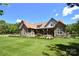 Charming exterior showcasing stone accents, manicured lawn, and inviting front porch at 114 Wingard Rd, Concord, NC 28025