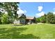 A lush green lawn surrounds the house with a large back patio, screened-in porch, and garden at 114 Wingard Rd, Concord, NC 28025