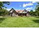 Charming exterior showcasing stone accents, manicured lawn, and inviting front porch at 114 Wingard Rd, Concord, NC 28025