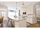 Open concept kitchen with island seating, stainless appliances, and a seamless flow to the dining area at 114 Wingard Rd, Concord, NC 28025