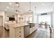 Stylish kitchen flows to living and dining area, featuring an island with seating and stainless steel appliances at 114 Wingard Rd, Concord, NC 28025