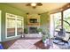 Comfortable screened-in porch with stone fireplace, TV, and pendant chair at 114 Wingard Rd, Concord, NC 28025