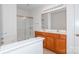 This bathroom features a dual sink vanity, mirrored walls, and tile flooring at 11863 Ridgeway Park Dr, Charlotte, NC 28277