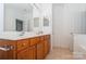 Bathroom showcases a dual sink vanity, mirrored walls, and tile flooring at 11863 Ridgeway Park Dr, Charlotte, NC 28277
