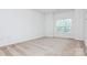 This bedroom is bright with neutral carpet and large window at 11863 Ridgeway Park Dr, Charlotte, NC 28277