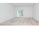 This bedroom includes neutral carpet and a glass door to a patio at 11863 Ridgeway Park Dr, Charlotte, NC 28277