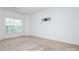 This bright bedroom has neutral carpet and a window overlooking the yard at 11863 Ridgeway Park Dr, Charlotte, NC 28277