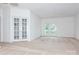 A bright living room with carpet, double doors and balcony access at 11863 Ridgeway Park Dr, Charlotte, NC 28277