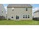 View of the back of the house, showcasing the lawn and the home's siding at 120 Mooring Dr, Statesville, NC 28677