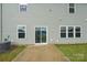 Backyard with a concrete patio and lush green grass extending towards the house at 120 Mooring Dr, Statesville, NC 28677